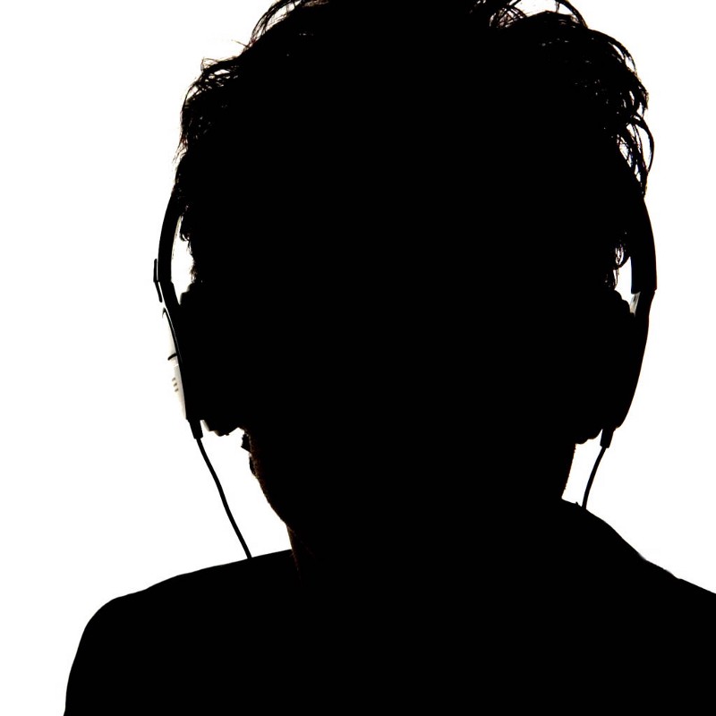 a silhouette of a man wearing headphones